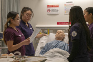 Students working on a sim mankin