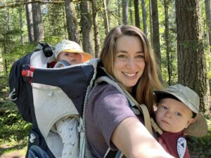 small children and adult standing with trees