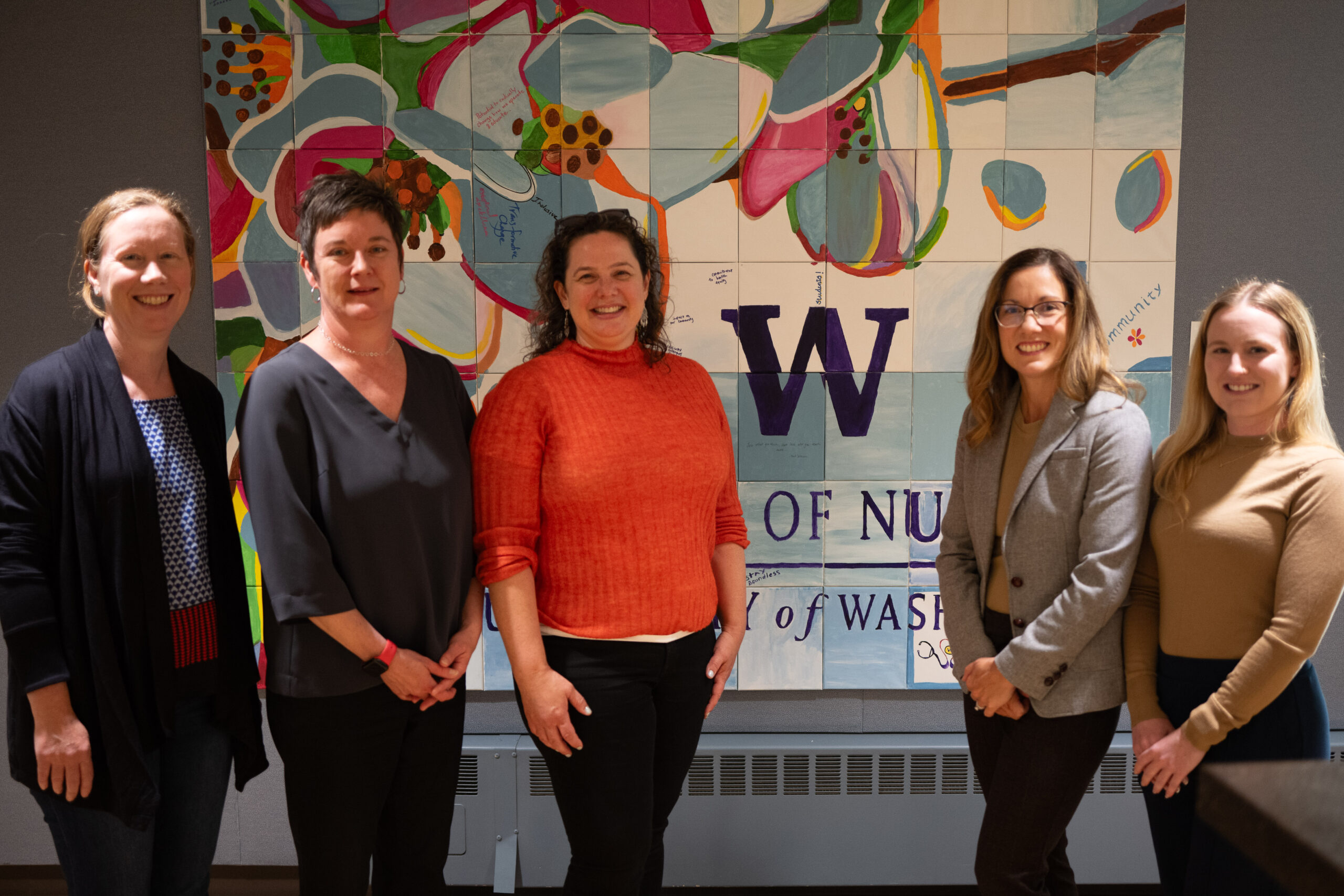 Five faculty smiling at camera