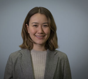 Person smiling to camera with grey background