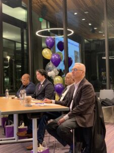 four persons sitting at a table with balloons