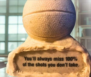 Close up of basketball desk figure with quote "You'll always miss 100% of the shots you don't take".