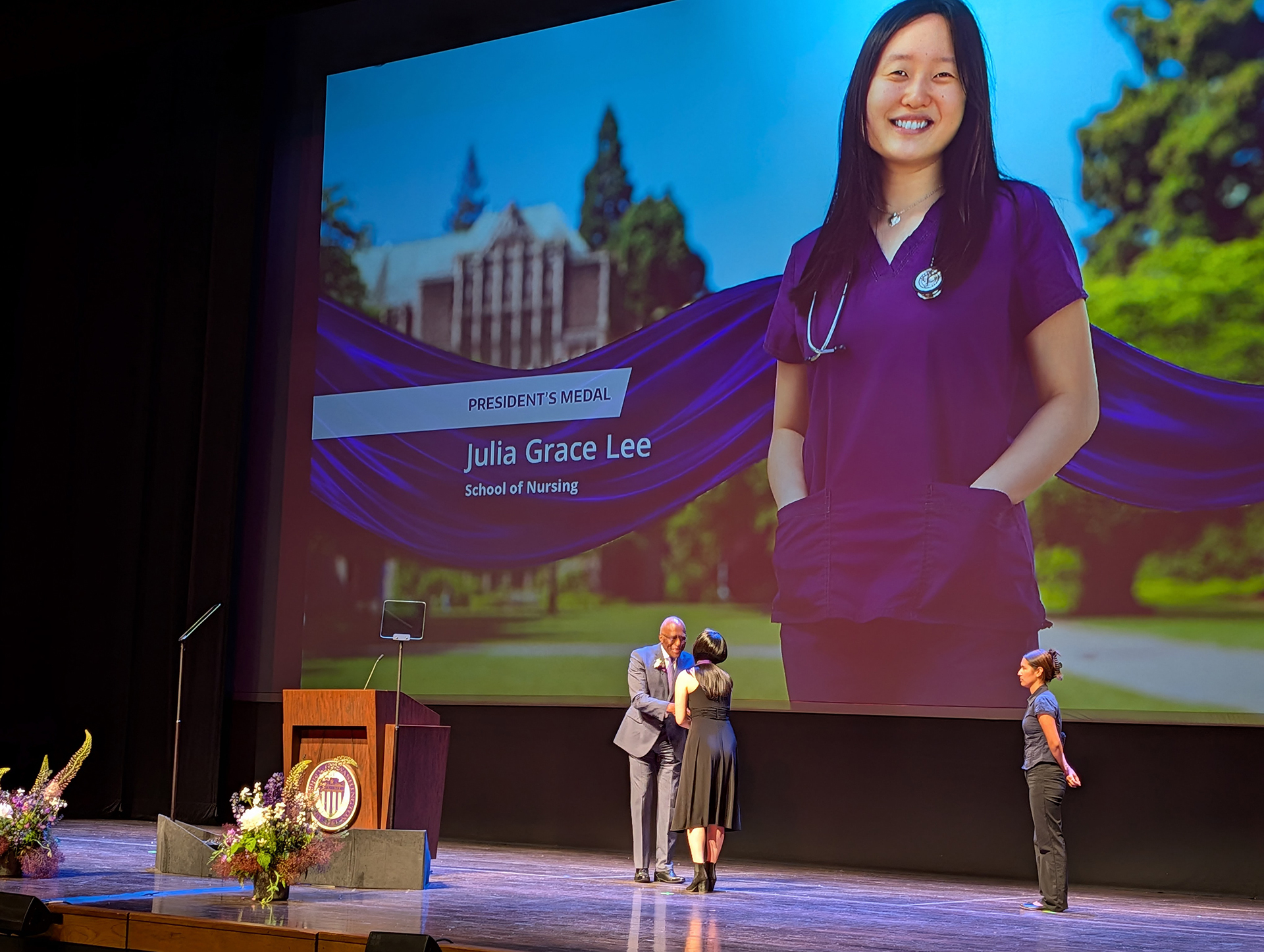 Woman on a stage accepting an award.
