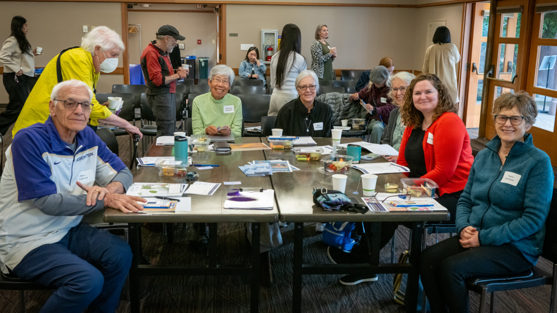 A group of Ignite Aging symposium attendees sitting at a big square table.