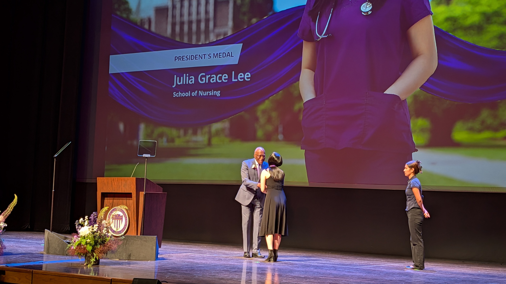 A woman receiving an award on stage.