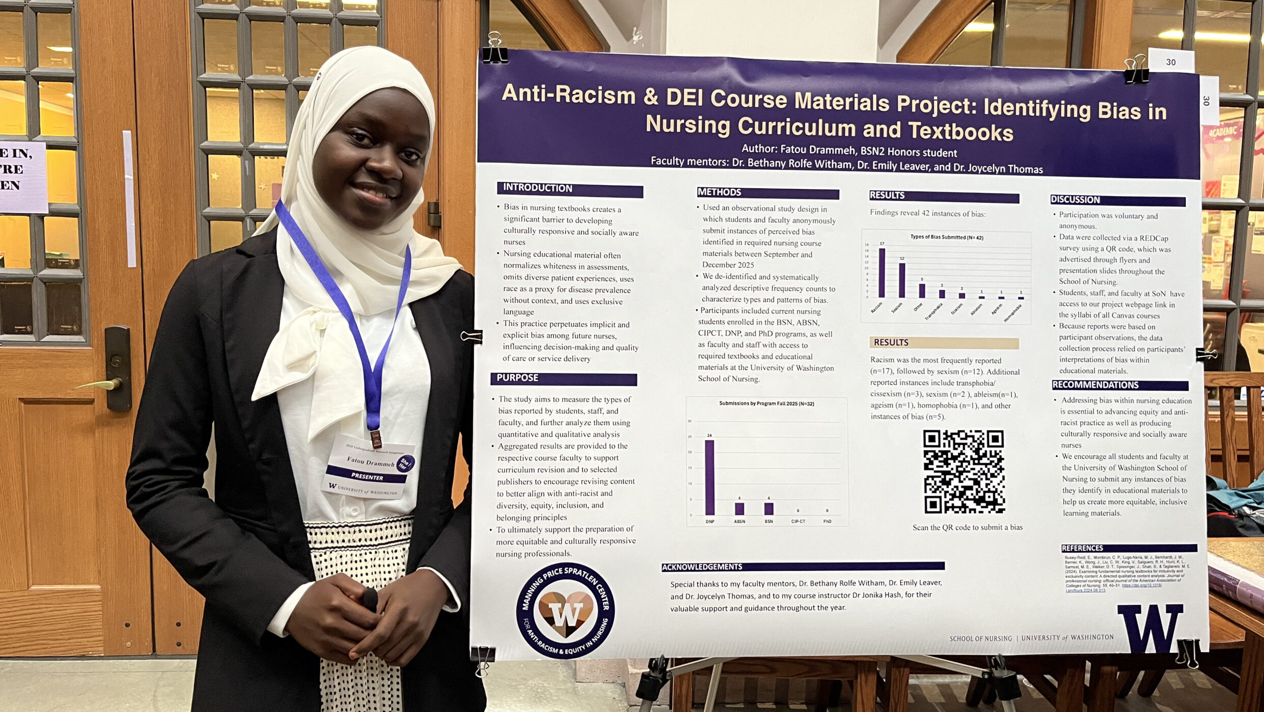 A woman student next to her research poster and posing and smiling at the camera.