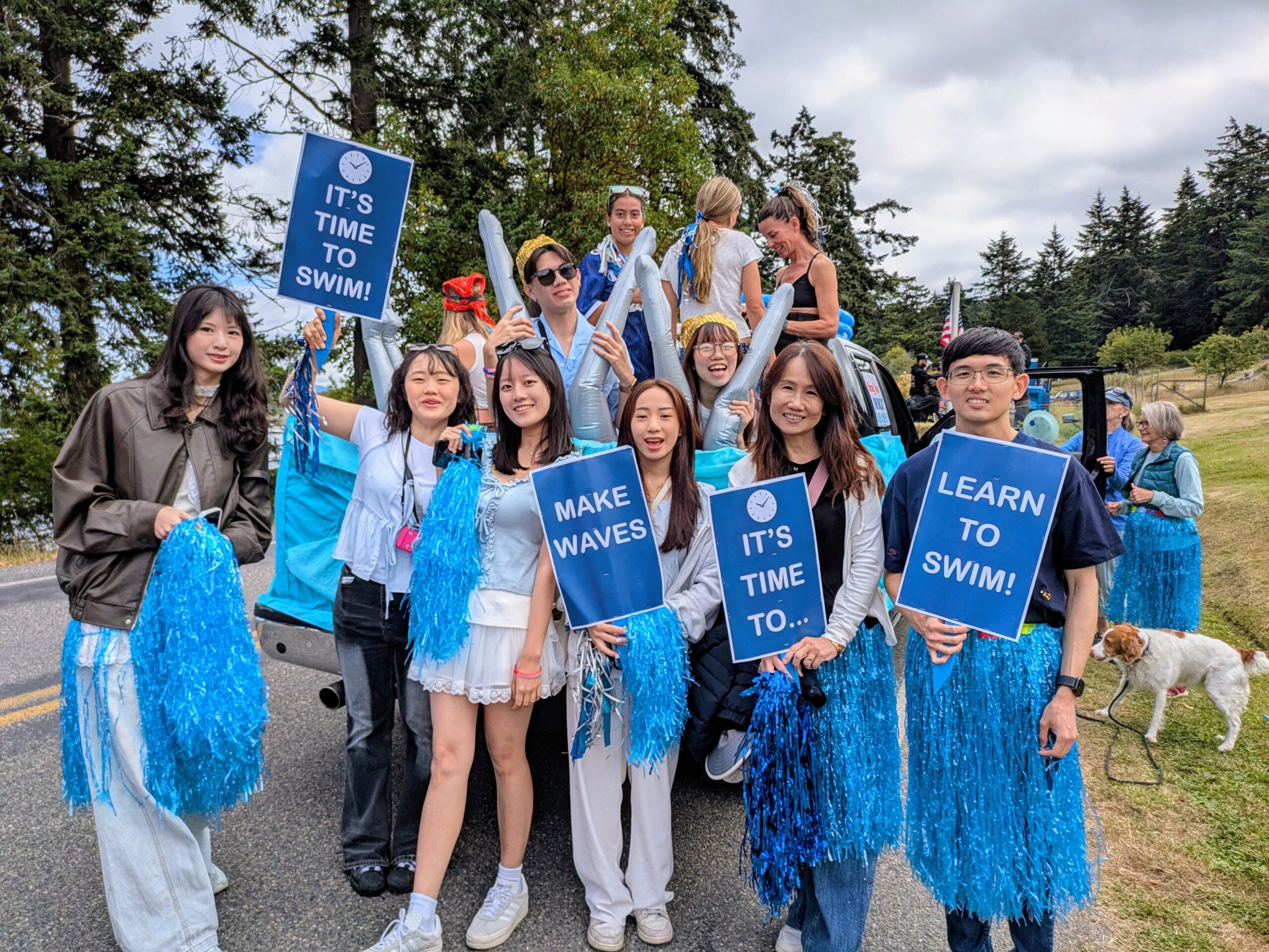 Students with signs celebrating a pool