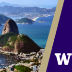 Coastal city view with a large rocky headland, calm blue bay, and distant mountains under a clear sky, with a purple panel on the right showing a white “W” logo.